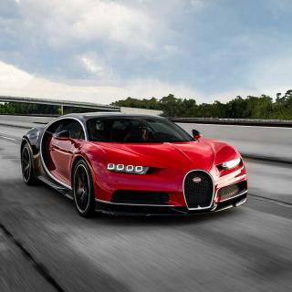 Image of red Bugatti sportscar on highway.