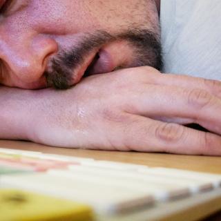 man sleeping on desk